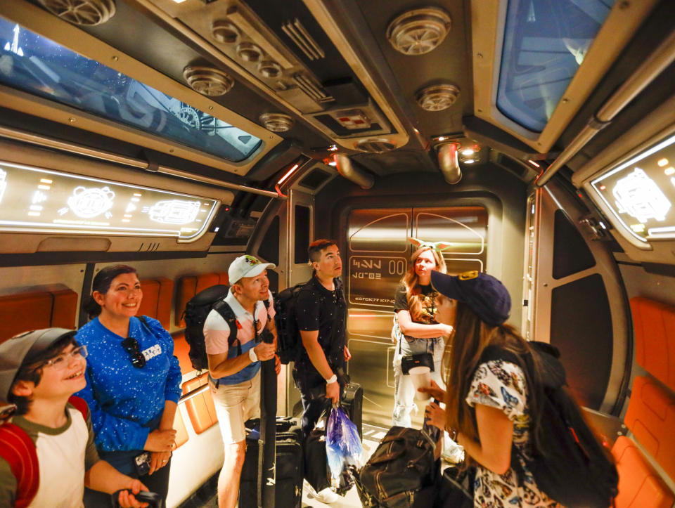 Orlando, Fla - March 01: Andrew Stapleton, 12, left, and his mom Malisa Stapleton, of Chicago, ride a transport ship from the Halcyon ship as the first passengers experience the two-day Walt Disney World  Star Wars Galactic Starcruiser, which is a live action role playing game that doubles as a high-end hotel in Orlando, Fla.  (Allen J. Schaben / Los Angeles Times via Getty Images)