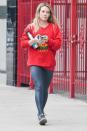 Hilary Duff leaves the gym in L.A. on Tuesday wearing a red sweatshirt and black leggings.