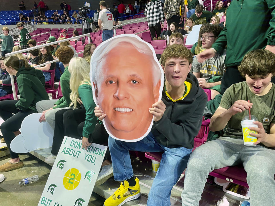 Greenbrier East High School student Parker Hill holds a cardboard cutout of Gov. Jim Justice at the West Virginia girls state basketball tournament Tuesday, March 5, 2024, in Charleston, W.Va. Justice is the girls basketball coach at Greenbrier East. (AP Photo/John Raby)