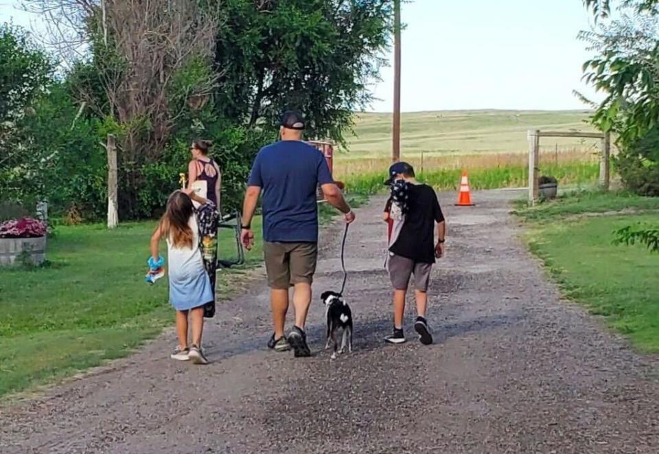 Cochell, his children and a dog they are fostering on a walk. / Credit: Ben Cochell
