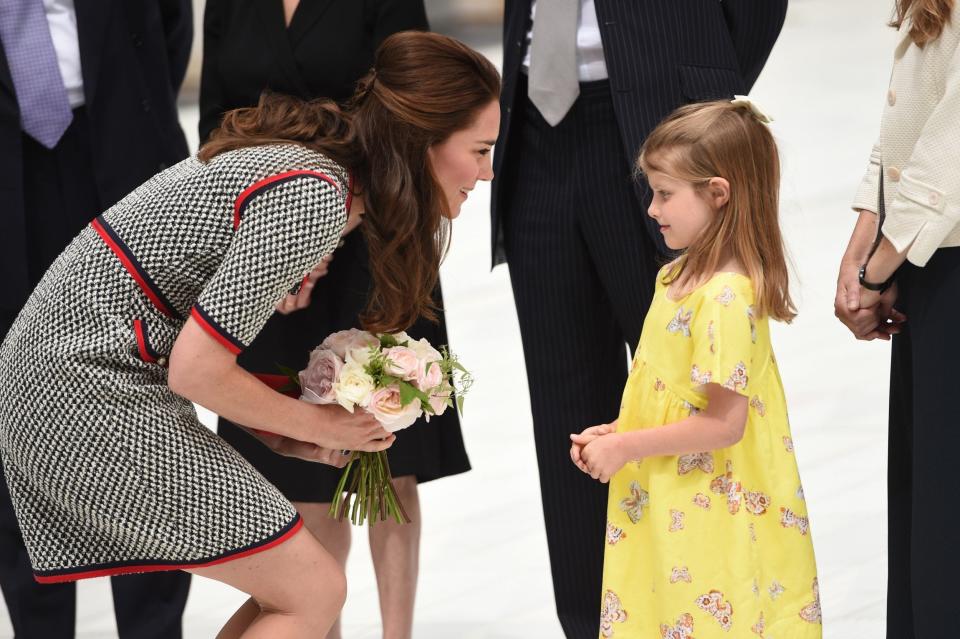 The Duchess receives flowers from a young girl - Credit: Eddie Mulholland for The Telegraph