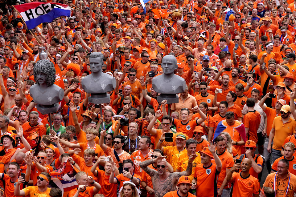 Fans of the team of the Netherlands walk towards the stadium ahead of a semifinal match between the Netherlands and England at the Euro 2024 soccer tournament in Dortmund, Germany, Wednesday, July 10, 2024. (AP Photo/Markus Schreiber)