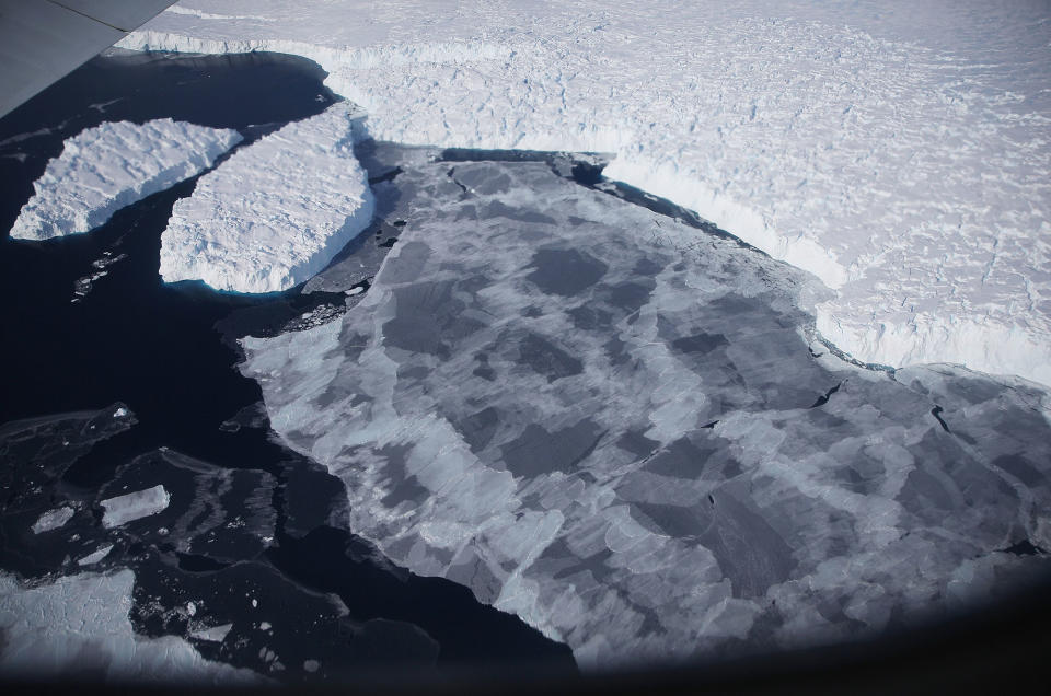 <p>Ice floats near the coast of West Antarctica as viewed from a window of a NASA Operation IceBridge airplane on October 28, 2016 in-flight over Antarctica. (Photo: Mario Tama/Getty Images) </p>