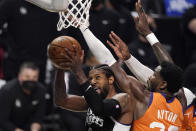 Los Angeles Clippers guard Paul George, left, shoots as Phoenix Suns center Deandre Ayton defends during the second half in Game 3 of the NBA basketball Western Conference Finals Thursday, June 24, 2021, in Los Angeles. (AP Photo/Mark J. Terrill)