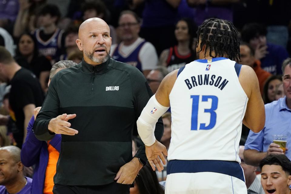 Dallas Mavericks head coach Jason Kidd, left, talks with Mavericks guard Jalen Brunson during the second half of Game 5 of an NBA basketball second-round playoff series against the Phoenix Suns Tuesday, May 10, 2022, in Phoenix. The Suns won 110-80. (AP Photo/Ross D. Franklin)