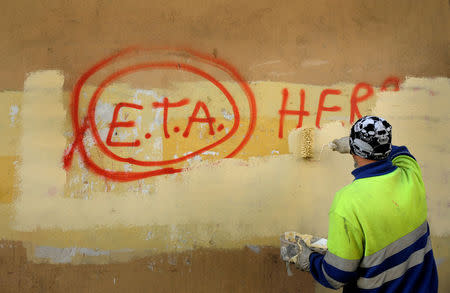 FILE PHOTO: A municipal worker paints over graffiti reading "ETA, The People Are With You" in Guernica October 21, 2011, the day after Basque separatist group ETA announced a definitive cessation of armed activity. Spanish Basque armed separatists ETA have called a definitive end to 50 years of armed struggle which has cost the lives of at least 850 people, the band said in a statement published in Basque language newspaper Gara. REUTERS/Vincent West/File Photo