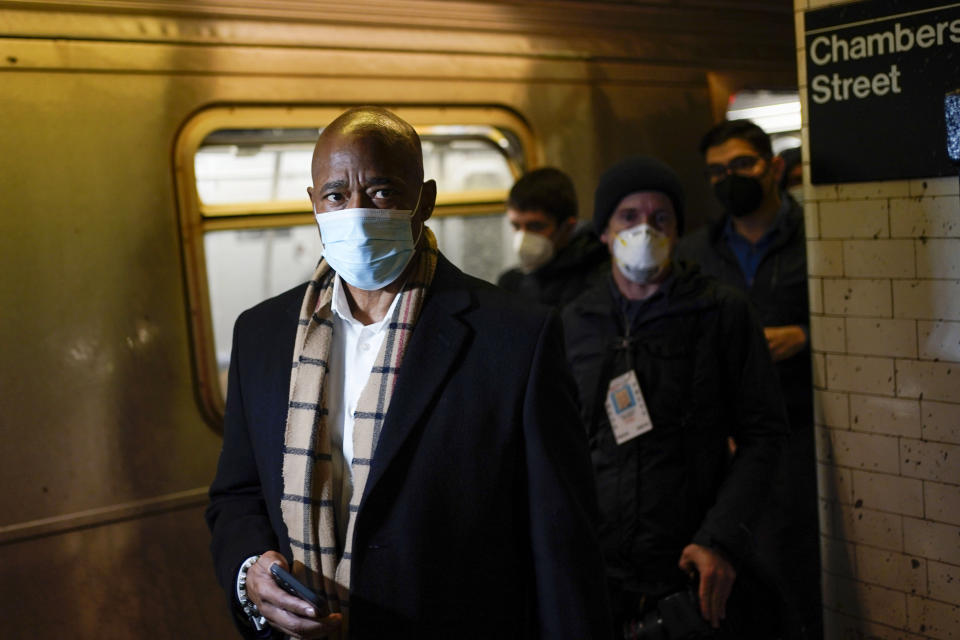 FILE - New York Mayor Eric Adams rides the subway to City Hall on his first day in office in New York, Jan. 1, 2022. For years, liberal cities in the U.S have tolerated people living in tents in parks and public spaces, but increasingly leaders in places like Portland, Oregon, New York and Seattle are removing encampments and pushing other strict measures that would've been unheard of a few years ago. In New York, Adams is making a push to try to remove people experiencing homelessness from the city's sprawling subway system with a plan to start barring people from sleeping on trains or riding the same lines all night. (AP Photo/Seth Wenig, File)