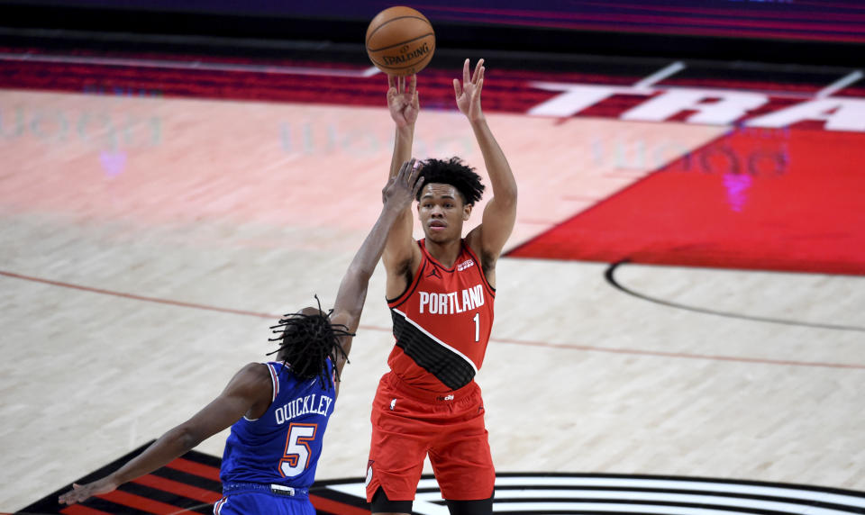 Portland Trail Blazers guard Anfernee Simons, right, hits a shot over New York Knicks guard Immanuel Quickley, left, during the first half of an NBA basketball game in Portland, Ore., Sunday, Jan. 24, 2021. (AP Photo/Steve Dykes)