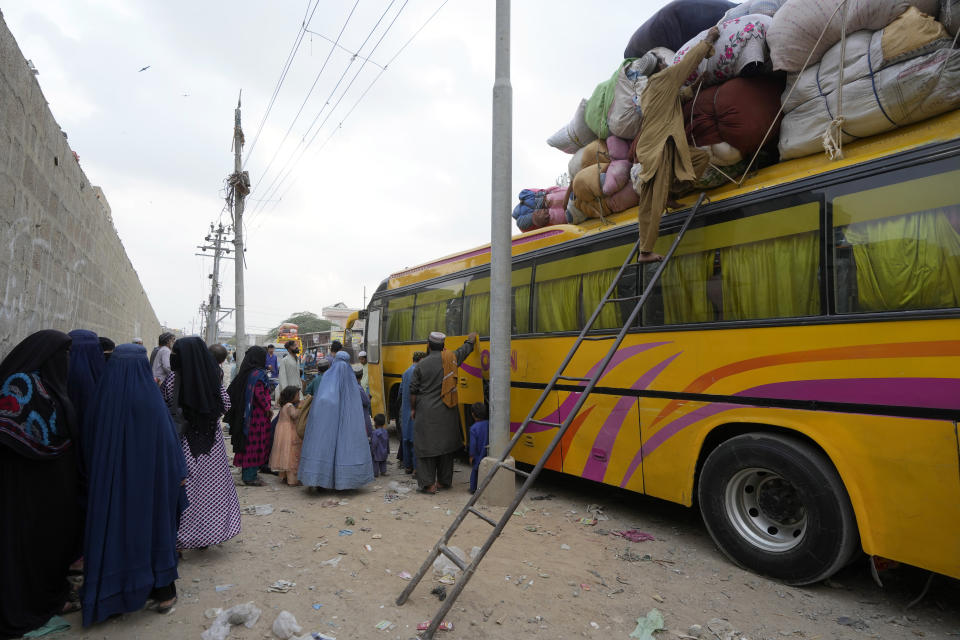 Afghan families board into a bus to depart for their homeland, in Karachi, Pakistan, Friday, Oct. 6, 2023. Pakistan's government announced a major crackdown Tuesday on migrants in the country illegally, saying it would expel them starting next month and raising alarm among foreigners without documentation who include an estimated 1.7 million Afghans. (AP Photo/Fareed Khan)