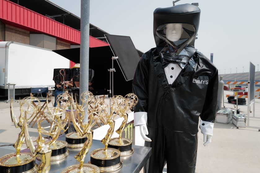 72ND EMMY® AWARDS - A mannequin in a tuxedo hazmat suit guards over the Emmy statuettes in preparation for the "72nd Emmy® Awards."