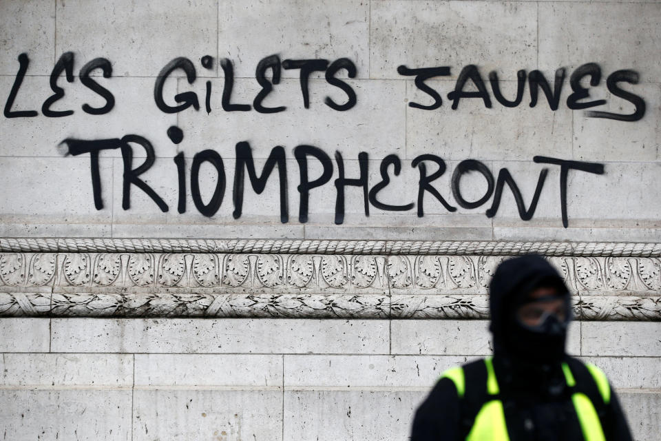 The slogan “The yellow vests will triumph” is seen on the Arc de Triomphe as protesters wearing yellow vests, a symbol of a drivers’ protest against higher diesel taxes, demonstrate at the Place de l’Etoile in Paris, Dec. 1, 2018. (Photo: Stephane Mahe/Reuters)