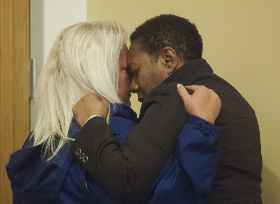 Marcia Williams, mother of Terrance Williams, is hugged by Monica Caison, founder of the CUE Center for Missing Persons, in 2013.