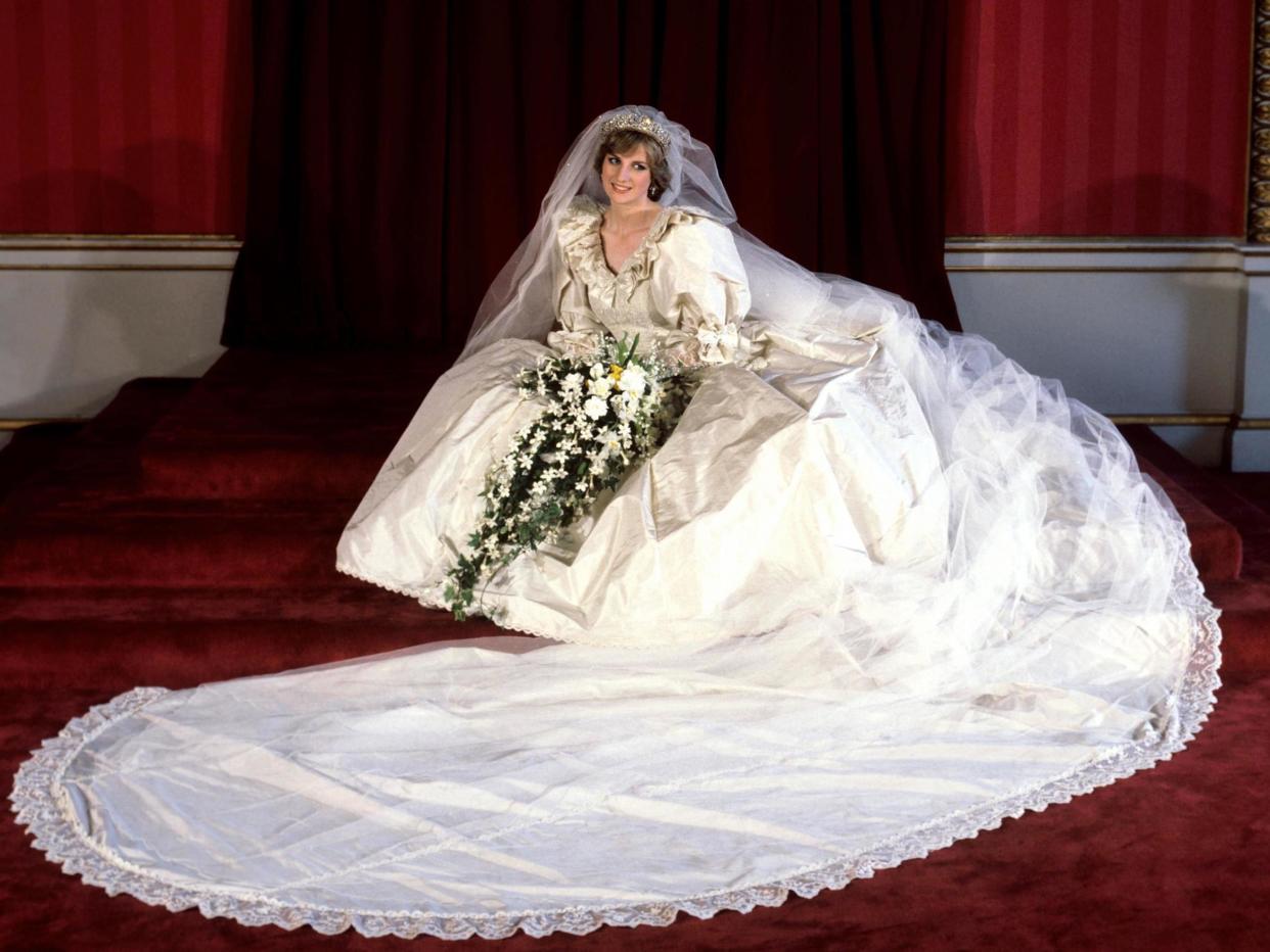 The Princess of Wales seated in her bridal gown at Buckingham Palace after her marriage to Prince Charles at St. Paul's Cathedral (PA/PA Archive/PA Images)