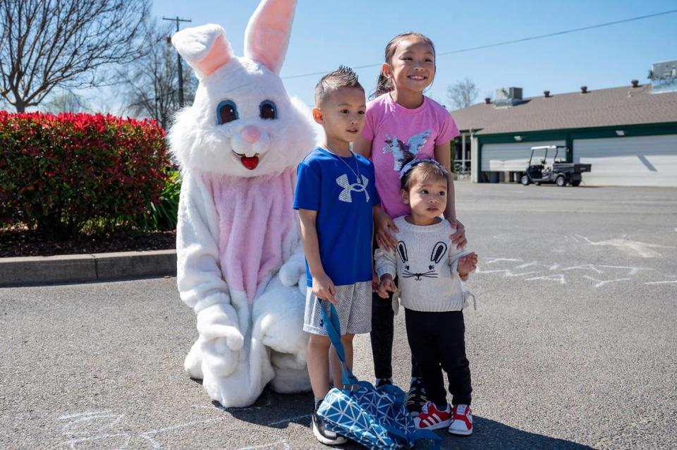 Siblings Jasalyn, 7, Aiden, 4, and Aria, 2, take a photo with the Easter Bunny during the Haggin Oaks Easter Egg Hunt on Sunday, April 9, 2023, in Sacramento.