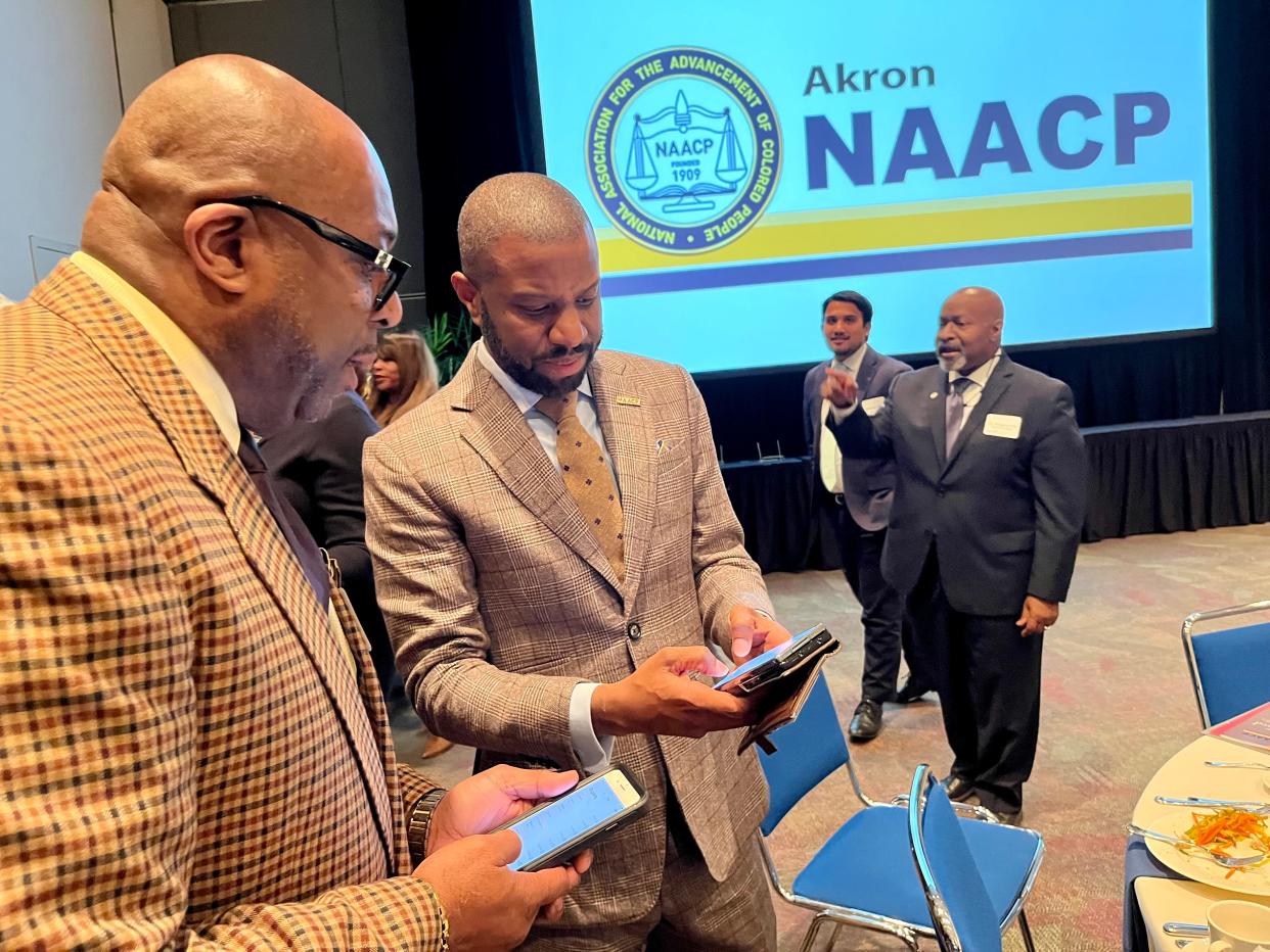 vory Toldson, national director of Education Innovation and Research for the NAACP, exchanges contact information with Akron School Board Member Bruce Alexander at the 2023 Akron NAACP Freedom Fund fundraiser event Sunday in Akron.