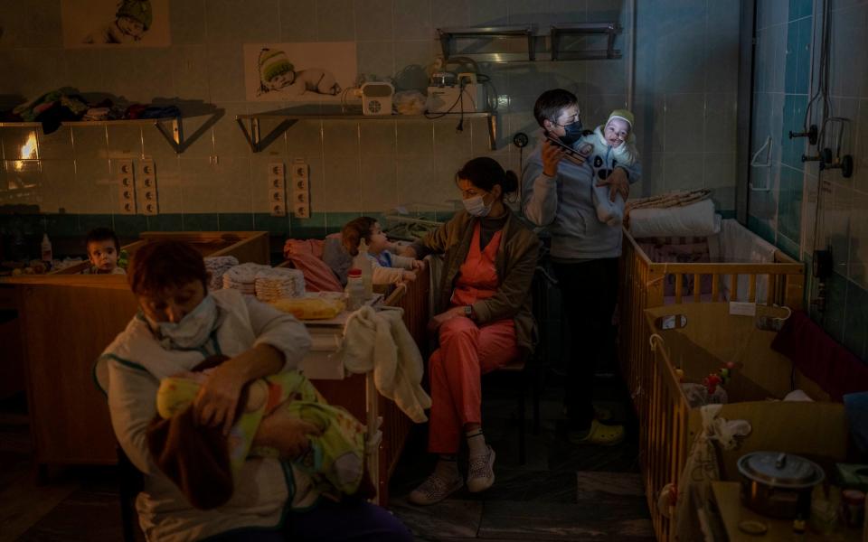 Hospital staff take care of orphans at the children's regional hospital maternity ward in Kherson - AP