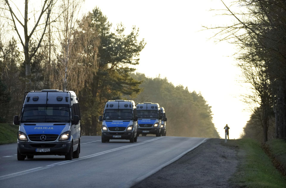 Polish police vans head to the reinforced border with Belarus near Kuznica, Poland, on Tuesday, Nov. 9, 2021. Hundreds of Middle East migrants tried to illegally force the border from Belarus into European Union member Poland the day before. Poland is strengthening the border with more guards. (AP Photo/Czarek Sokolowski)