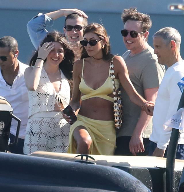 Elon Musk chats with brunette flaunting serious side boob while watching  Miami Grand Prix