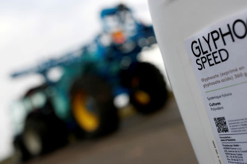 FILE PHOTO: A can of glyphosate weedkiller is seen in front of a tractor with a pulveriser system as French farmer Herve Fouassier attends an interview with Reuters in Ouzouer-sous-Bellegarde