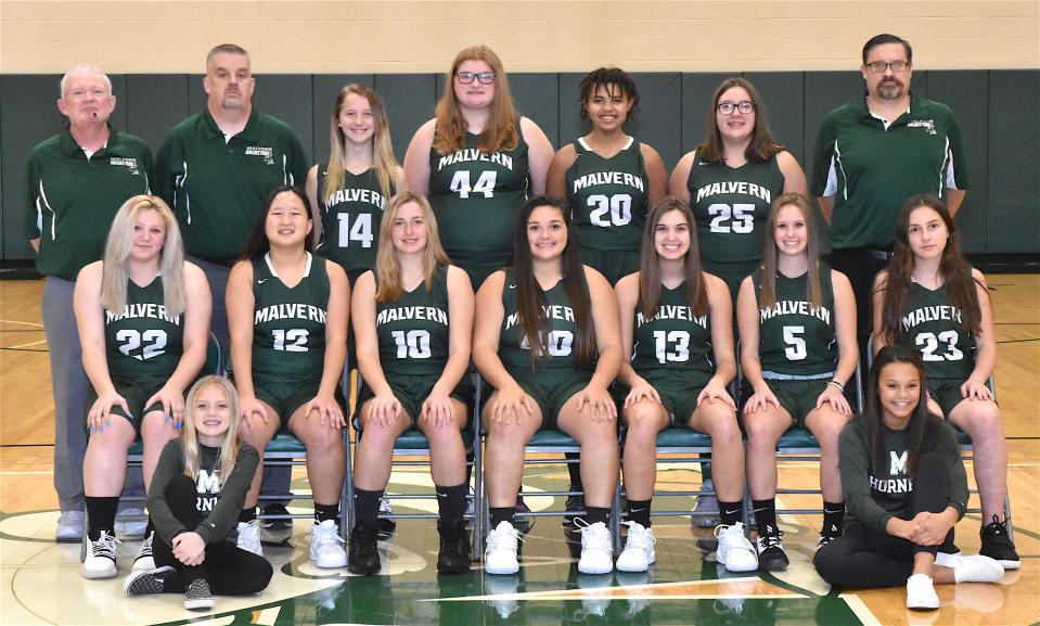 Randy Casper (back row, far left) Members of the 2020-21 Malvern varsity girls basketball team are (front row, left to right) managers Avery Sprague and Whitney Smith; (second row) Lexi Klotz, Marella Smith, Raine Coblentz, Alana Spurrier, Maddie Powers, Lanie Bower and Alyssa Boni; and (back row) Coach Randy Casper, Coach Brian Steffey, Emma Debo, Nicolena Theiss, Alyiah Watson, Isabella Evans and Head Coach Jason Powers.