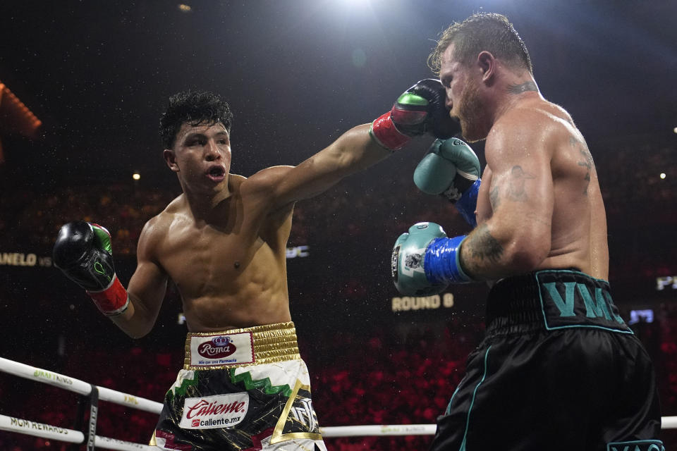 Jaime Munguia lands a left to Canelo Alvarez in a super middleweight title fight Saturday, May 4, 2024, in Las Vegas. (AP Photo/John Locher)