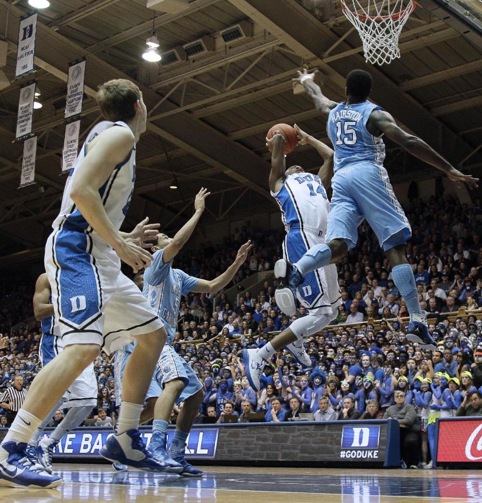 Duke's Rasheed Sulaimon (14) drives to the basket as North Carolina's P.J. Hairston (15) defends during the first half of an NCAA college basketball game in Durham, N.C., Wednesday, Feb. 13, 2013. (AP Photo/Gerry Broome)