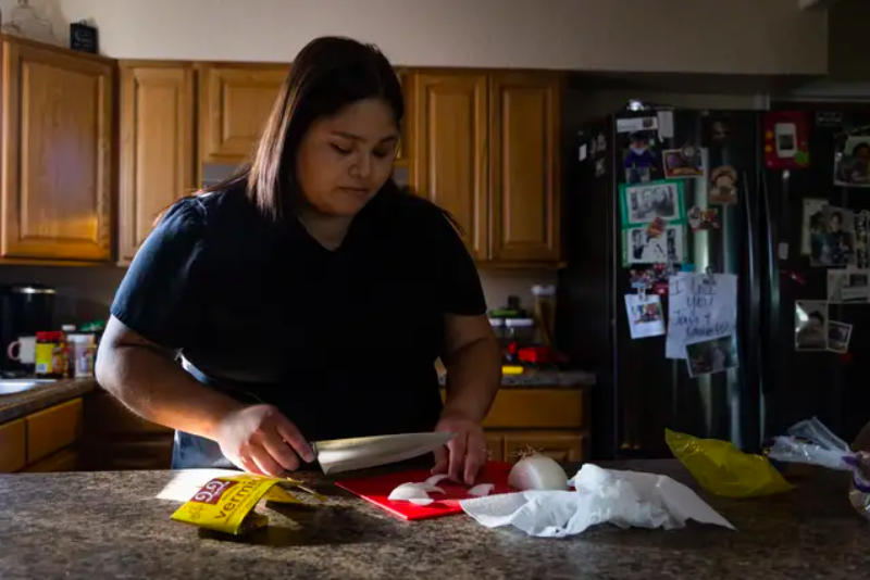 Brianna Gonzales prepares dinner for herself and her two sons at home in Uvalde on Aug. 10. (Evan L’Roy/The Texas Tribune)