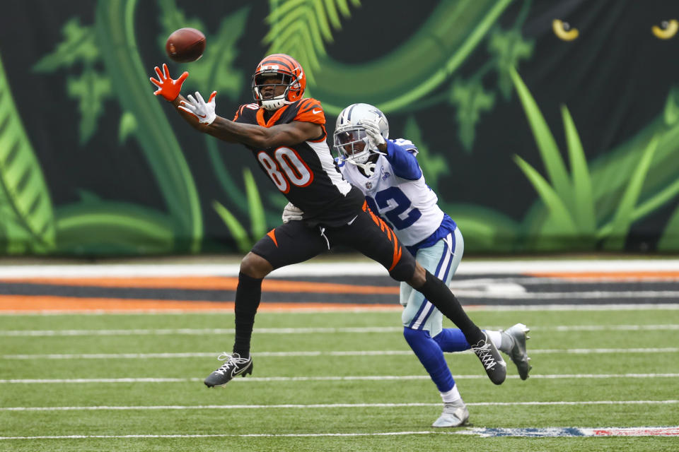 Cincinnati Bengals wide receiver Mike Thomas (80) makes a catch in front of Dallas Cowboys cornerback Saivon Smith (32) in the first half of an NFL football game in Cincinnati, Sunday, Dec. 13, 2020. (AP Photo/Aaron Doster)