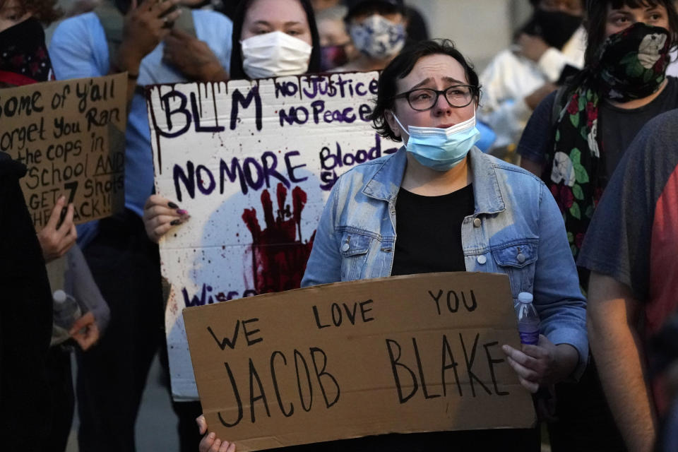 People gather Tuesday, Aug. 25, 2020 to protest in Kenosha, Wis. Anger over the Sunday shooting of Jacob Blake, a Black man, by police spilled into the streets for a third night. (AP Photo/Morry Gash)
