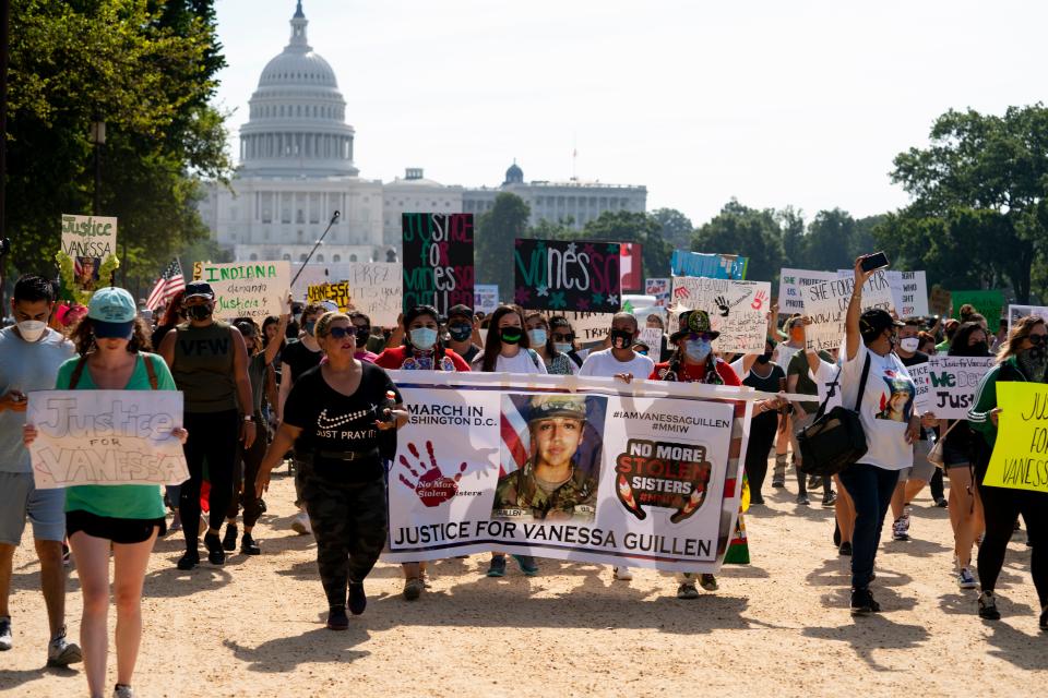 Supporters of the family of slain Army Spc. Vanessa Guillen march to the White House along the National Mall as Capitol Hill is seen in the distance after a news conference, in Washington on July 30, 2020.