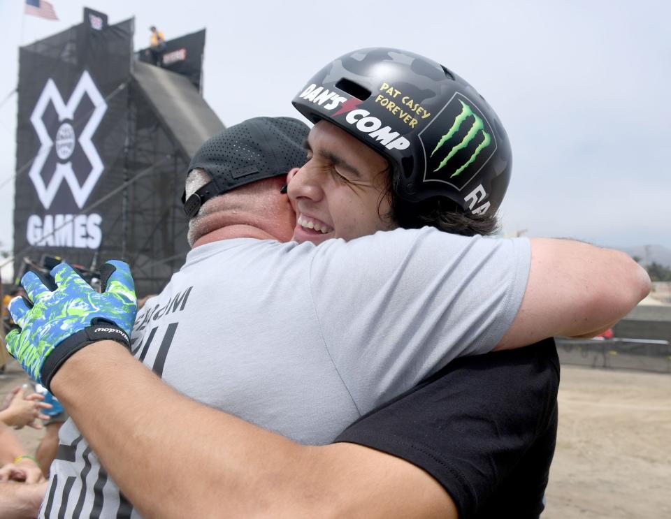 Brady Baker hugs his father Alex Baker after winning gold in the BMX Dirt Contest at the X Games competition at the Ventura County Fairgrounds on Saturday, July 22, 2023.