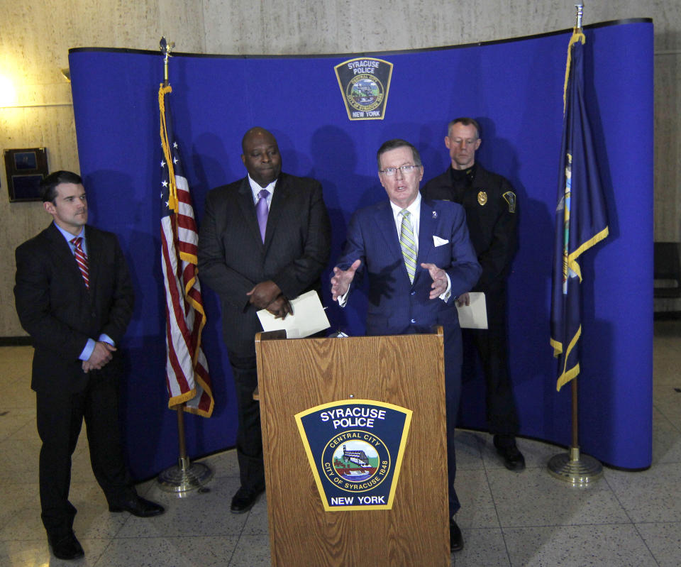 Onondaga County District Attorney William J. Fitzpatrick, center, speaks at a news conference at the Syracuse Police Department in Syracuse, N.Y., Thursday, Feb. 21, 2019, about Syracuse men's NCAA college basketball head coach Jim Boeheim's involvement in a fatal car accident where he struck and killed a man standing along an interstate in Syracuse. Boeheim struck and killed a man along an interstate late Wednesday night as he tried to avoid hitting the man's disabled vehicle, police say. (AP Photo/Nick Lisi)