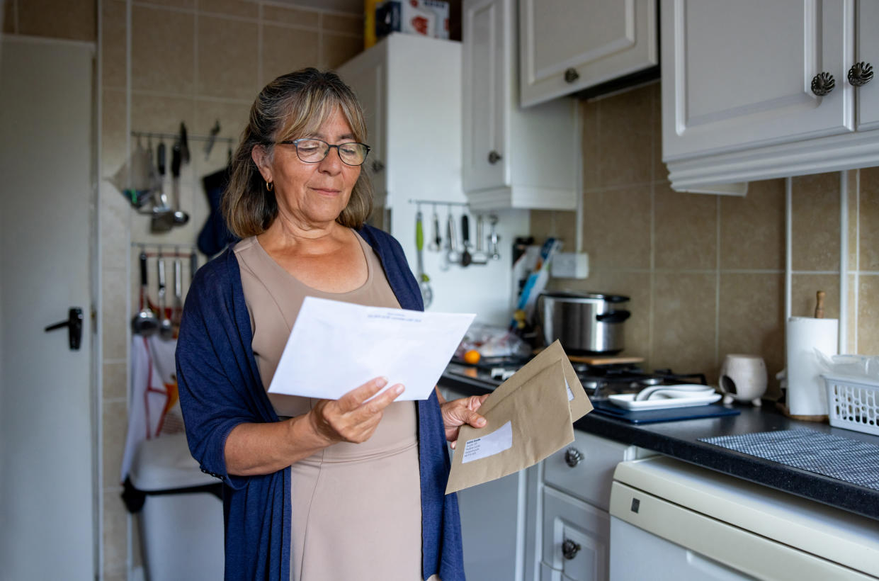 rent Portrait of a senior woman at home checking a letter in the mail - domestic life concepts