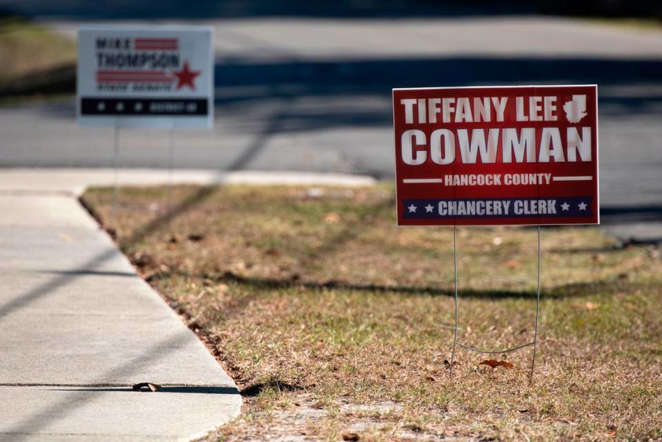 Candidate signs are posted outside a voting precinct in Bay St. Louis on Election Day. Voters are choosing a governor and other state and county officials.