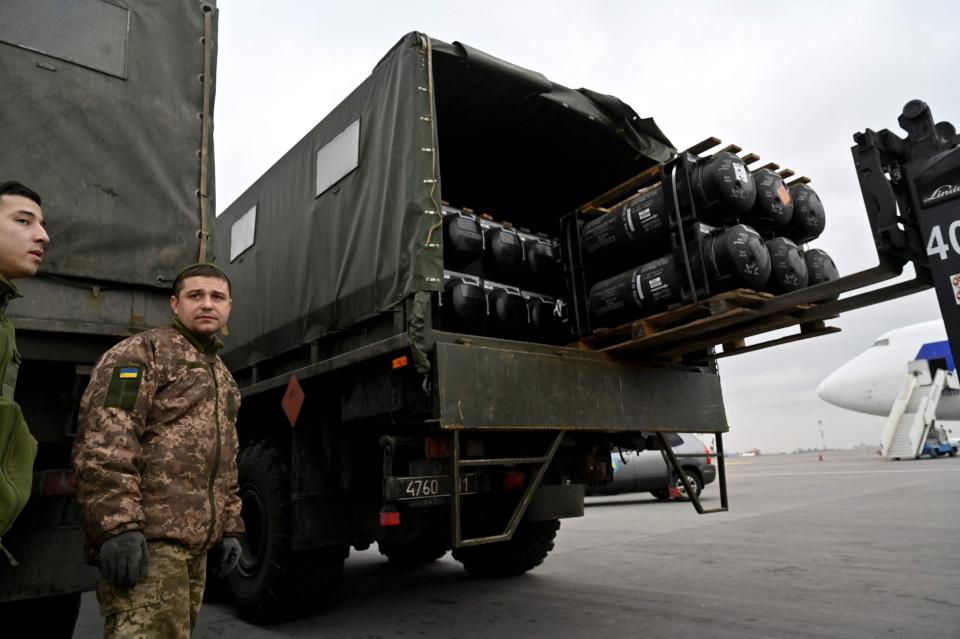 Ukrainian servicemen load a truck with the FGM-148 Javelin, American man-portable anti-tank missile provided by the United States, upon its delivery at Kyiv's airport Boryspil on Feb. 11, 2022