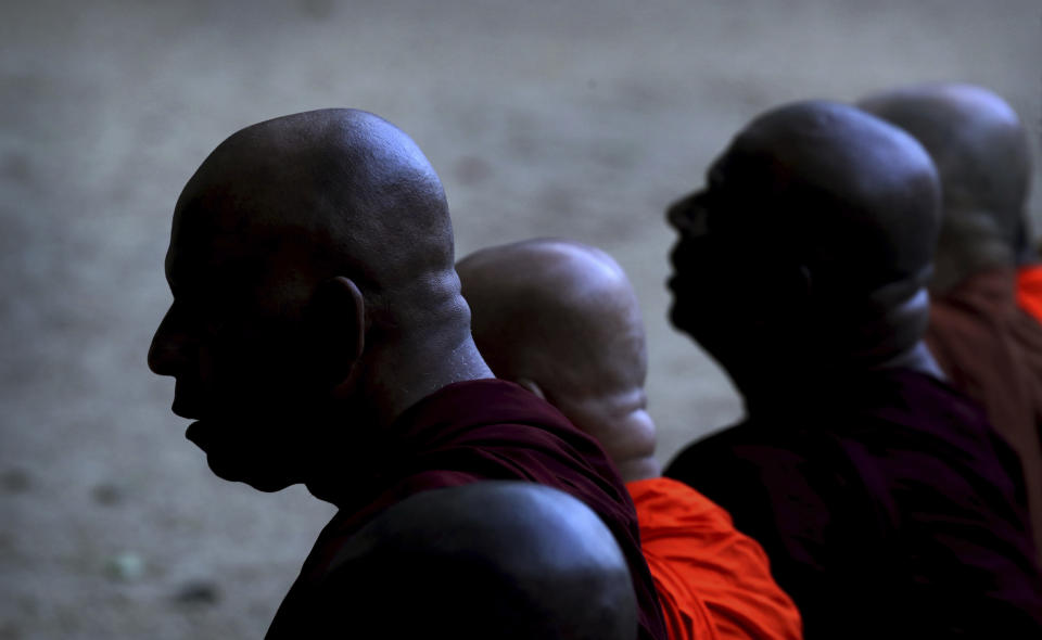 FILE - In this Wednesday, April 24, 2019 file photo, Buddhist monks offer prayers during a ceremony to invoke blessings on the dead and wounded from Sunday's bombings, at the Kelaniya temple in Colombo, Sri Lanka. Roughly 250 people died in six coordinated suicide bombings that ripped through Sri Lanka on Easter Sunday. (AP Photo/Manish Swarup, File)