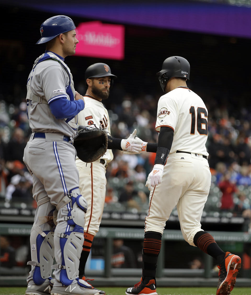 San Francisco Giants' Aramis Garcia (16) is congratulated by Kevin Pillar after hitting a two run home run off Toronto Blue Jays' Edwin Jackson in the second inning of a baseball game Wednesday, May 15, 2019, in San Francisco. At left is Toronto catcher Luke Maile. (AP Photo/Ben Margot)