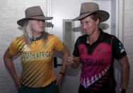 Dane van Niekerk of South Africa, left, and Sophie Devine, of New Zealand try on a traditional Australian hat called an Akubra after a press conference with captains of the 10 countries participating in the Women's T20 World Cup in Sydney, Monday, Feb. 17, 2020. The tournament begins Friday, Feb. 21. (AP Photo/Rick Rycroft)