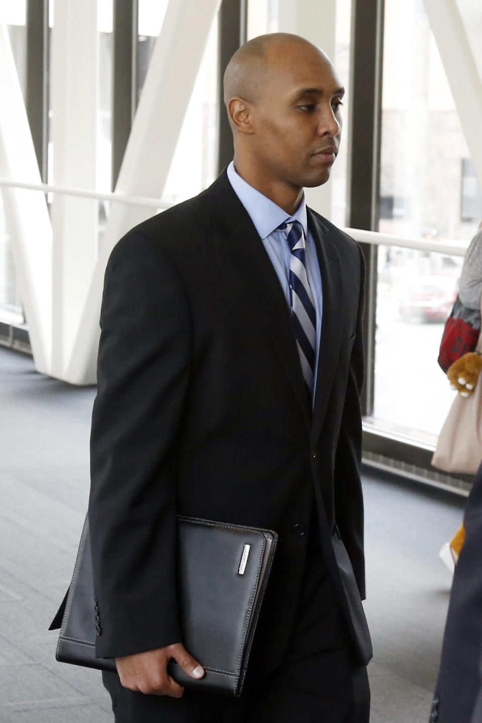 CORRECTS TO APRIL 25, 2019-Mohamed Noor, the former Minneapolis police officer, follows behind his attorneys as he arrives at the Hennepin County Government Center Thursday, April, 25, 2019 in Minneapolis in the fourth week of his trial. Noor is charged with second-degree intentional murder, third-degree murder and second-degree manslaughter in the July 15, 2017, shooting death of Justine Ruszczyk Damond, a 40-year-old life coach and Australian-American who had called 911 to report a possible sexual assault behind her home. (AP Photo/Jim Mone)