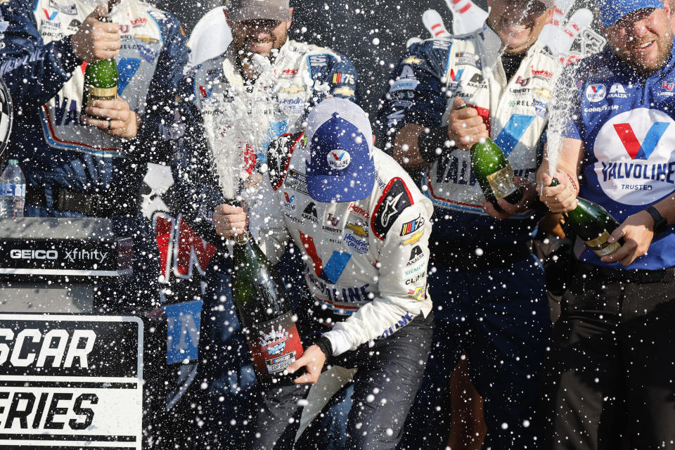 William Byron celebrates with his pit crew following a NASCAR Cup Series auto race in Watkins Glen, N.Y., Sunday, Aug. 20, 2023. (AP Photo/Jeffrey T. Barnes)