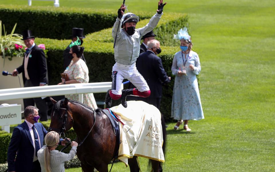 Jockey Frankie Dettori performs his trademark flying dismount as he celebrates winning the Queen Anne Stakes on Palace Pier - PA Wire