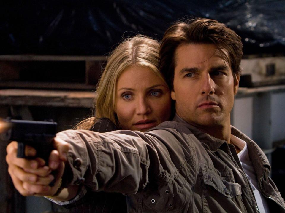 Cameron Diaz and Tom Cruise in "Knight and Day," holding a gun