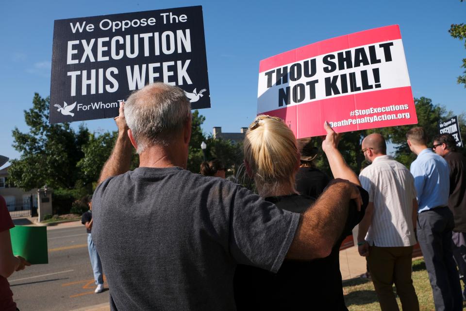 People opposed to the death penalty gather Thursday, Aug. 25, 2022, near the Oklahoma Governor's Mansion along NE 23 Street to protest the execution of James Coddington.