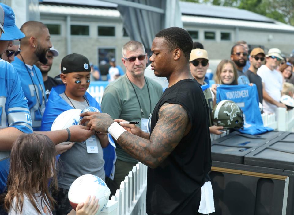 Lions running back David Montgomery signs autographs at the end of training camp on Wednesday, Aug. 02, 2023, in Allen Park.