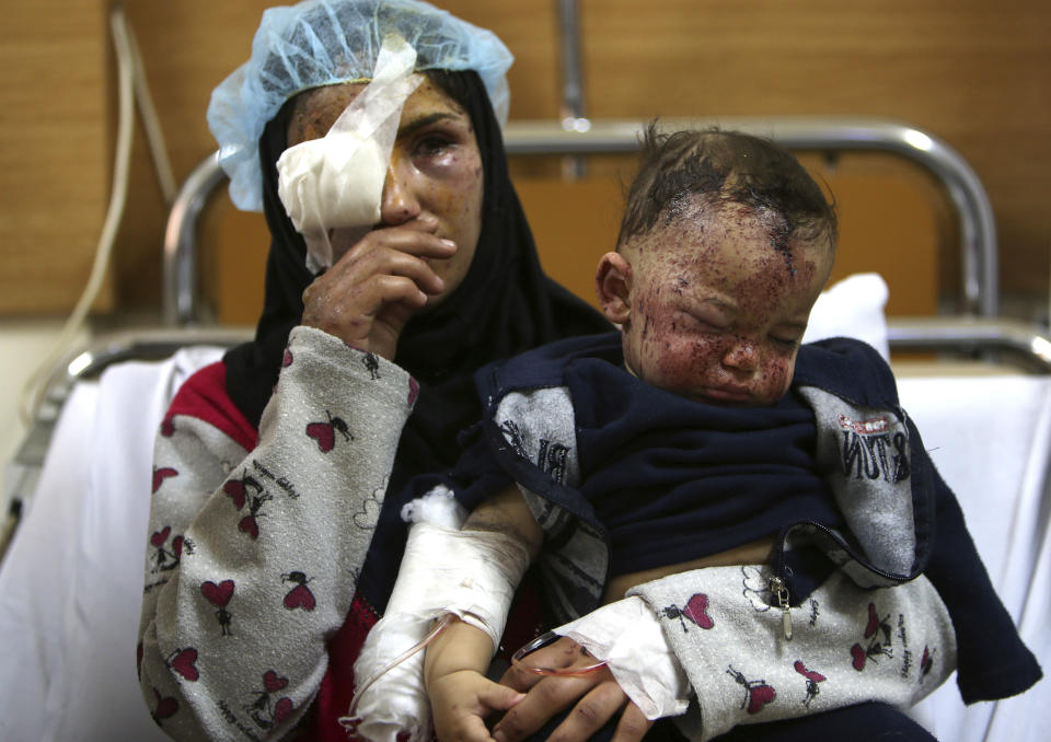 A Lebanese woman, Ghadeer Mortada, 18, who was wounded along with three members of her family, holds her one-year-old boy, Mohammed, in a hospital, after a deadly car bomb exploded Saturday evening, in the predominately Shiite town of Hermel, about 10 miles (16 kilometers) from the Syrian border in northeast Lebanon, Sunday, Feb. 2, 2014. A shadowy Lebanese Sunni extremist group late Saturday claimed responsibility for a suicide car bombing in Hermel, a stronghold of Lebanon's Shiite militant Hezbollah group, that killed several people in the latest attack linked to the war in neighboring Syria. (AP Photo/Hussein Malla)