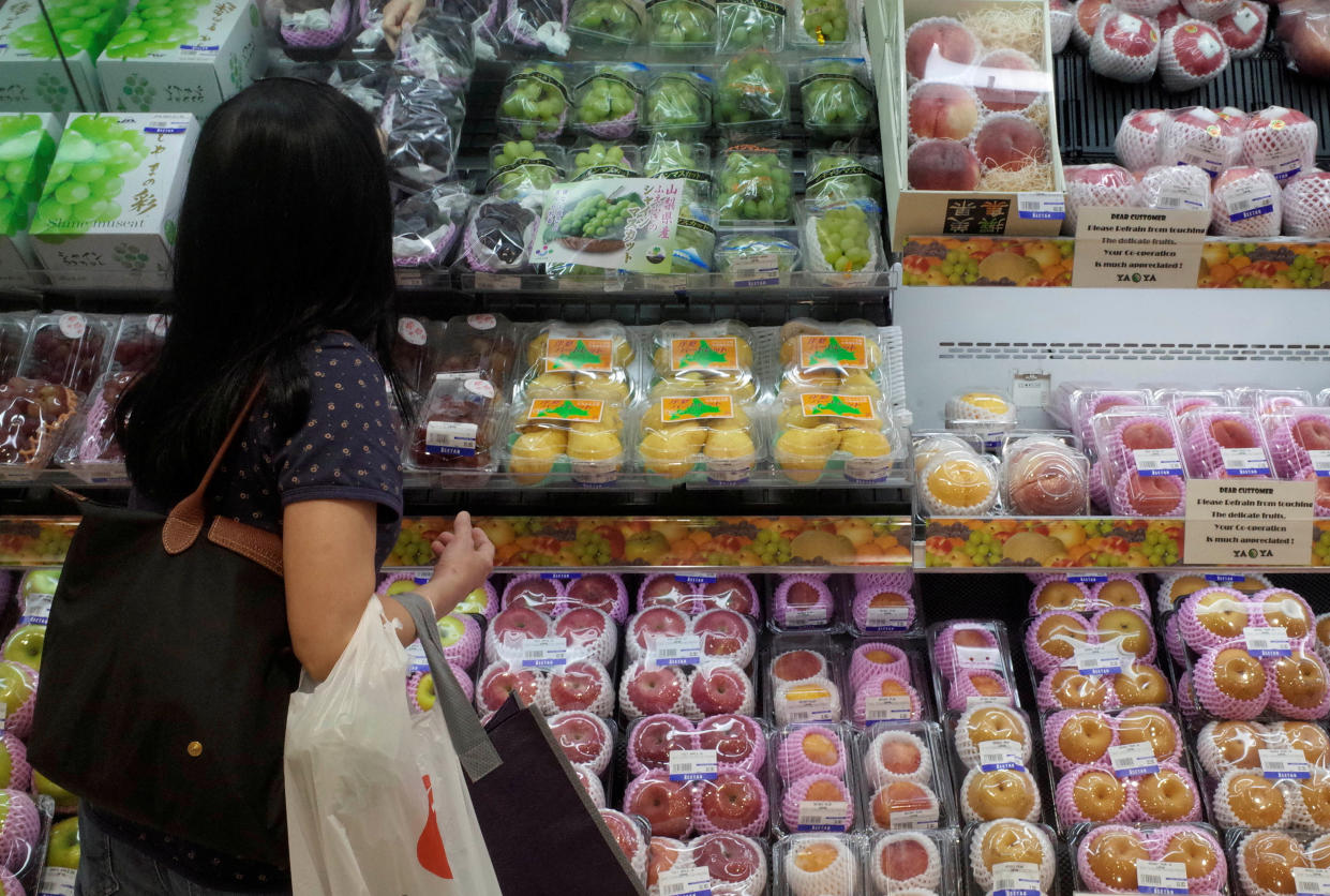 A woman shops for fruits at a supermarket in Singapore