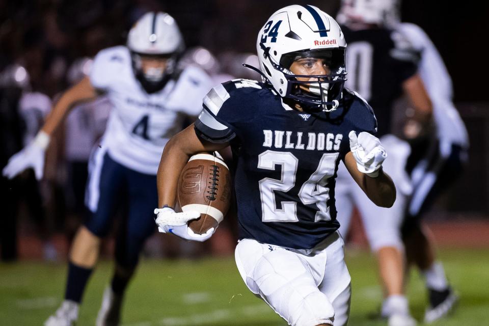 West York running back Za'Mir Harris carries the ball for the Bulldogs during a non-conference football game against ELCO at West York Area High School Friday, August 25, 2023.