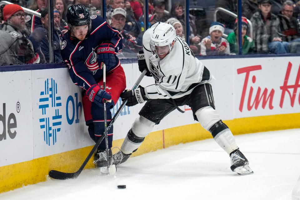 Dec 11, 2022; Columbus, Ohio, United States;  Columbus Blue Jackets center Jack Roslovic (96) fights with Los Angeles Kings center Anze Kopitar (11) for the puck during the third period of the NHL hockey game between the Columbus Blue Jackets and the Los Angeles Kings at Nationwide Arena. Mandatory Credit: Joseph Scheller-The Columbus Dispatch