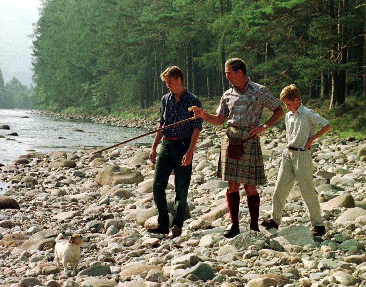 The Prince of Wales and his sons William, 15, and Harry, 12, take an early morning walk along the banks of the River Dee on the Balmoral estate in 1997 (PA)