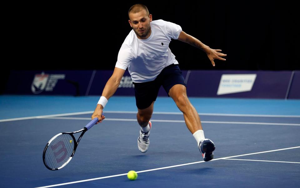 Dan Evans stretches for the ball - GETTY IMAGES